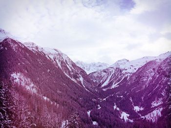 Scenic view of snow covered mountains against sky