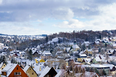 High angle view of houses in town against sky