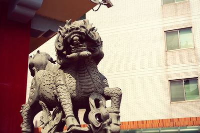 Low angle view of statue against building