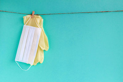Close-up of clothes drying against blue sky