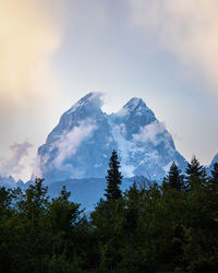 Low angle view of snowcapped mountains against sky