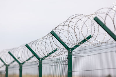 Fencing of sensitive sites with barbed wire. barbed wire. restriction of freedom. prison fence