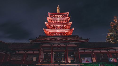 Low angle view of illuminated building against sky at night