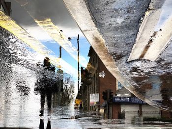 Reflection of buildings in puddle