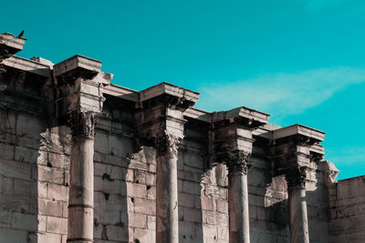 Low angle view of old ruins against blue sky