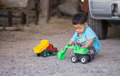 Boy playing with toys on field