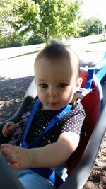 Portrait of happy boy sitting on bench