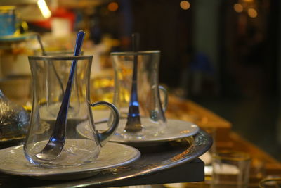 Close-up of empty plate and glasses on table