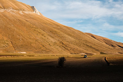 Scenic view of mountain road against sky in castelluccio, umbria italy 