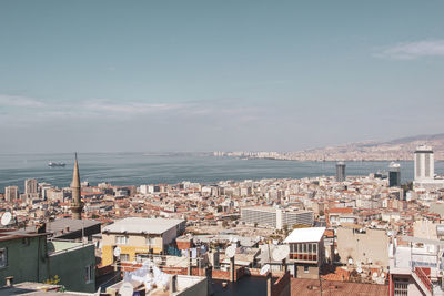 High angle view of townscape by sea against sky