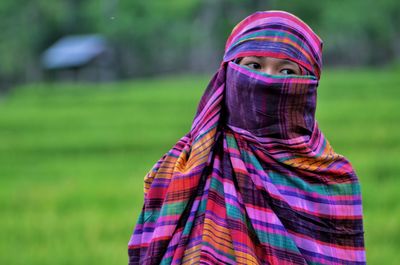 Woman wearing burka looking away while standing outdoors