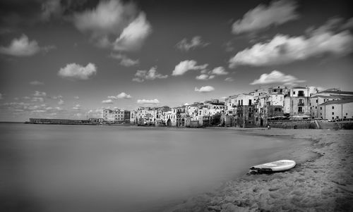 View of calm river with buildings in background