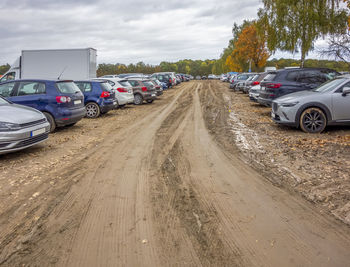 Cars on road against sky in city