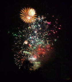 Low angle view of firework display at night