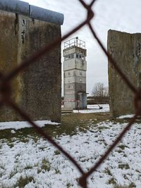 Snow covered field by building