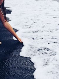 Low section of woman standing on beach