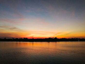 Scenic view of lake against romantic sky at sunset