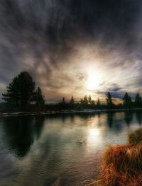 Scenic view of lake against cloudy sky