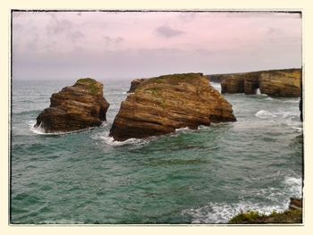 Scenic view of sea against cloudy sky