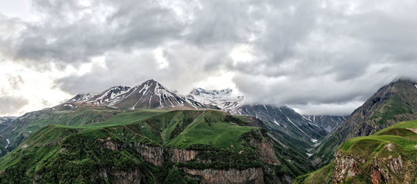 Panoramic view of snowcapped mountains against sky