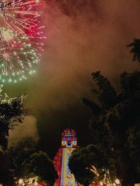 Low angle view of firework display at night