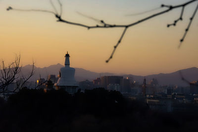 Cityscape against sky at sunset