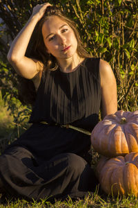 Portrait of a beautiful brunette girl with pumpkins