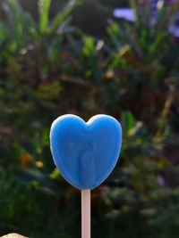 Close-up of heart shaped balloons against blue sky