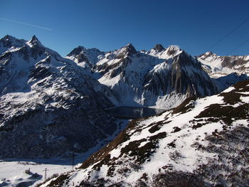 Scenic view of snowcapped mountains against clear sky