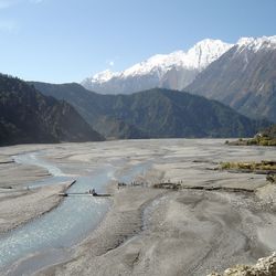 Scenic view of lake by mountains against sky