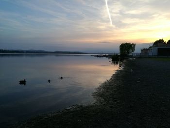 Scenic view of lake against sky during sunset