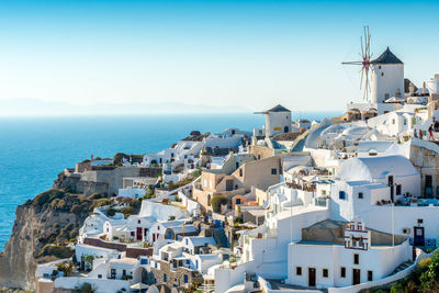 Townscape by sea against clear sky