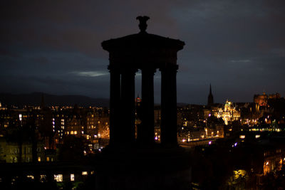 Illuminated building against sky at night