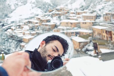 Man photographing in snow