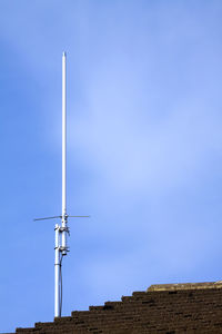 Low angle view of windmill against clear blue sky