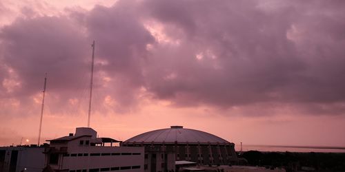 Low angle view of buildings against sky during sunset