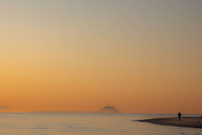 Scenic view of sea against orange sky