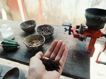 Close-up of grinding cocoa beans with a manual grinder