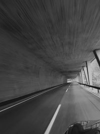 Empty road passing through tunnel