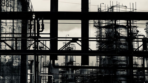 Low angle view of silhouette construction site against sky