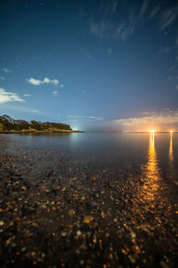 Scenic view of sea against sky at night