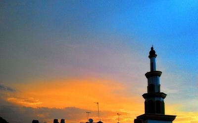 Low angle view of tower at sunset