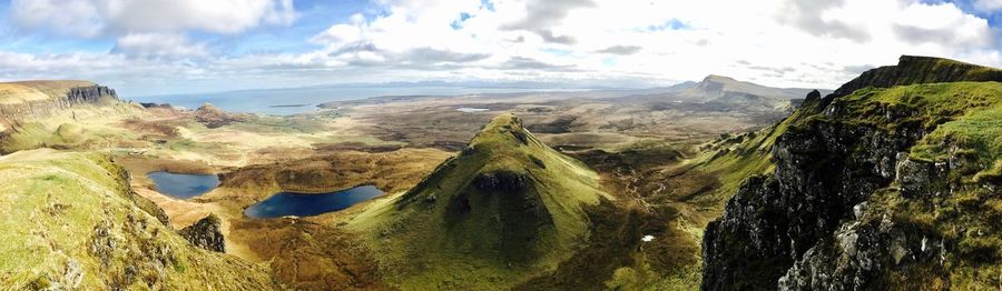 Panoramic view of sea and mountains against sky