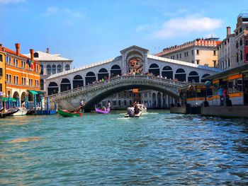 View of boats in canal along buildings