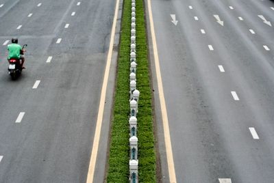 High angle view of man riding motorcycle on road