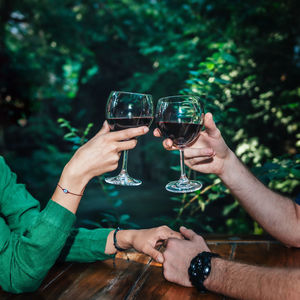 Couple toasting wineglasses at table in restaurant