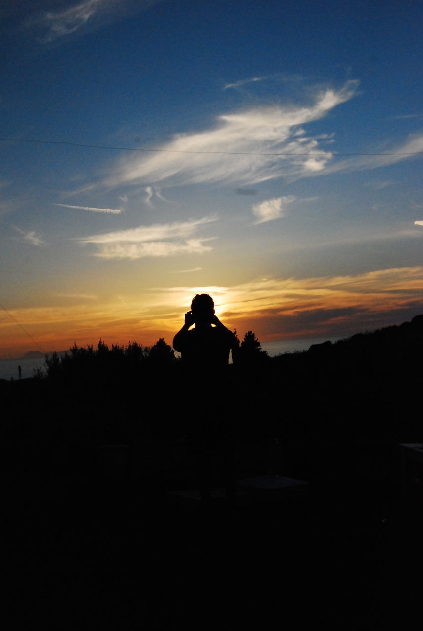 SILHOUETTE PEOPLE ON LANDSCAPE DURING SUNSET