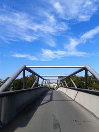 Footbridge against blue sky