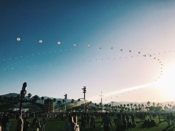 Group of people at music concert against sky