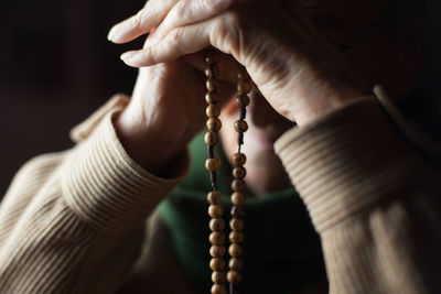 Close-up of hand holding cross